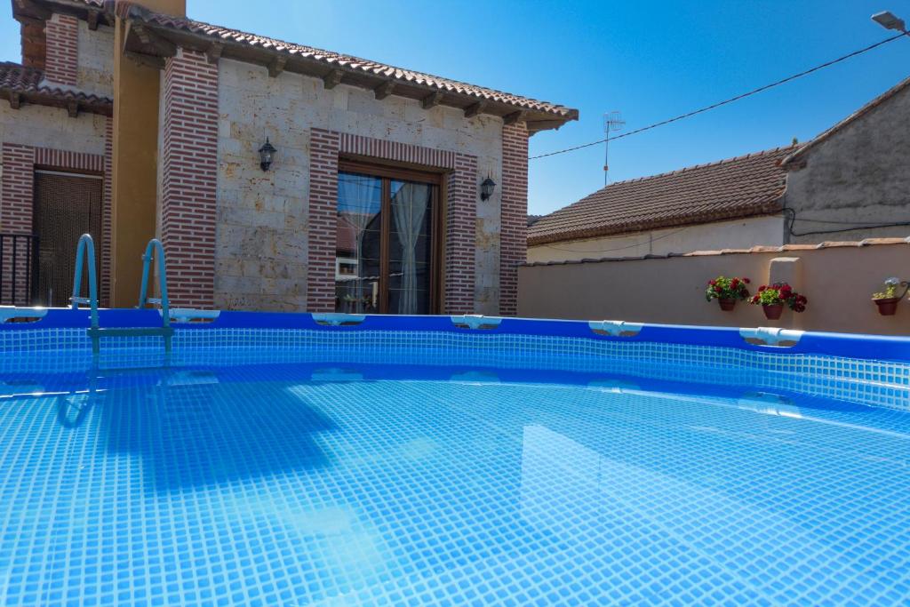 a swimming pool in front of a house at LOS ALISOS in Coca