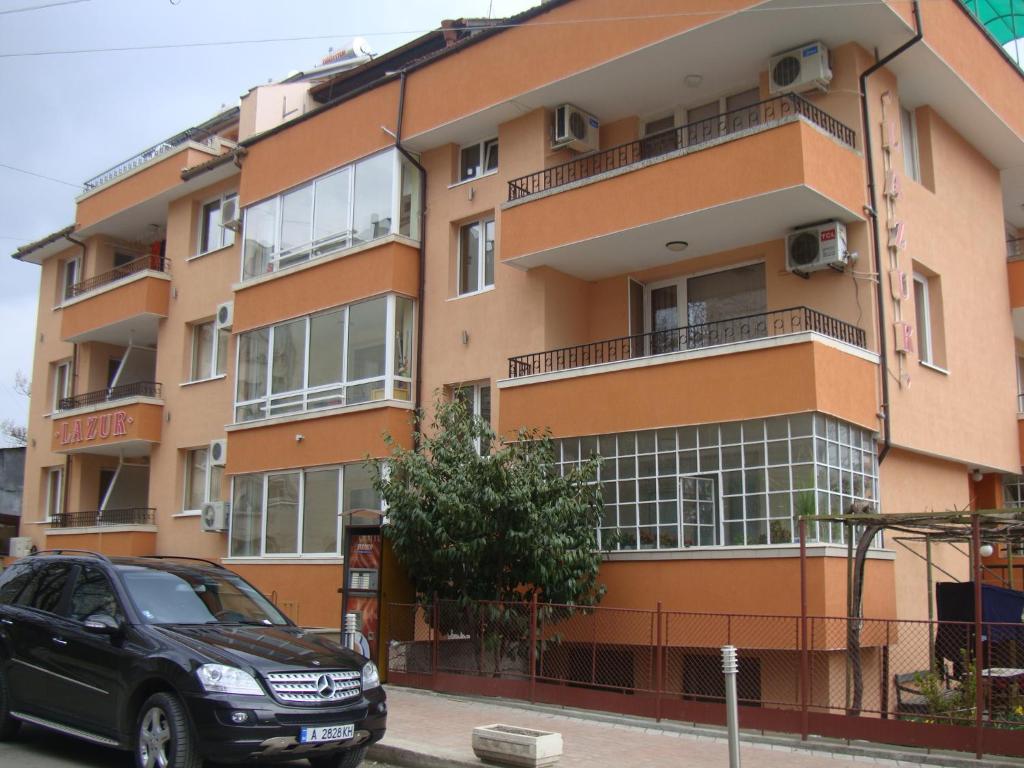 a black car parked in front of a building at Guest House Lazur in Burgas