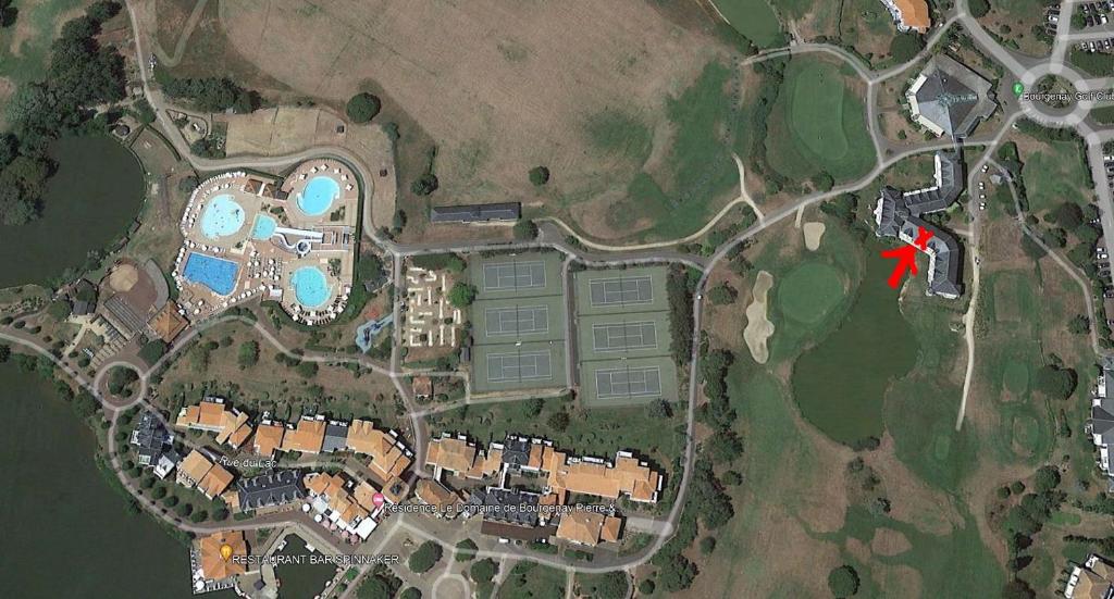 a map of a resort with a red arrow at Next to Golf-club House in Talmont