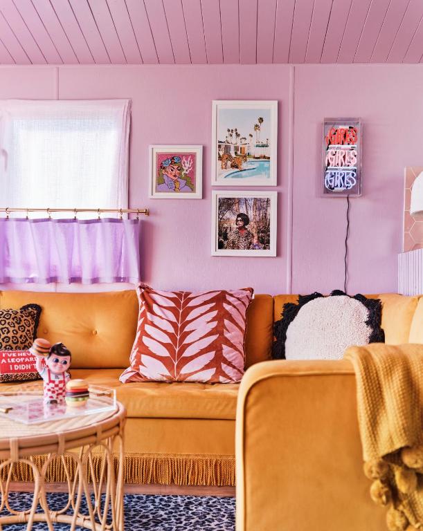 a living room with a couch and a table at Fun Barbie Inspired, 6 Berth Caravan - Camber Sands Holiday Park, near the Beach in Camber