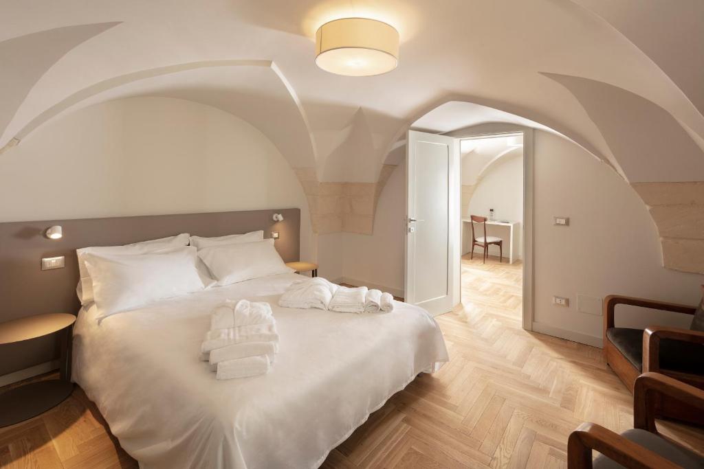 Postel nebo postele na pokoji v ubytování Palazzo dei Tolomei