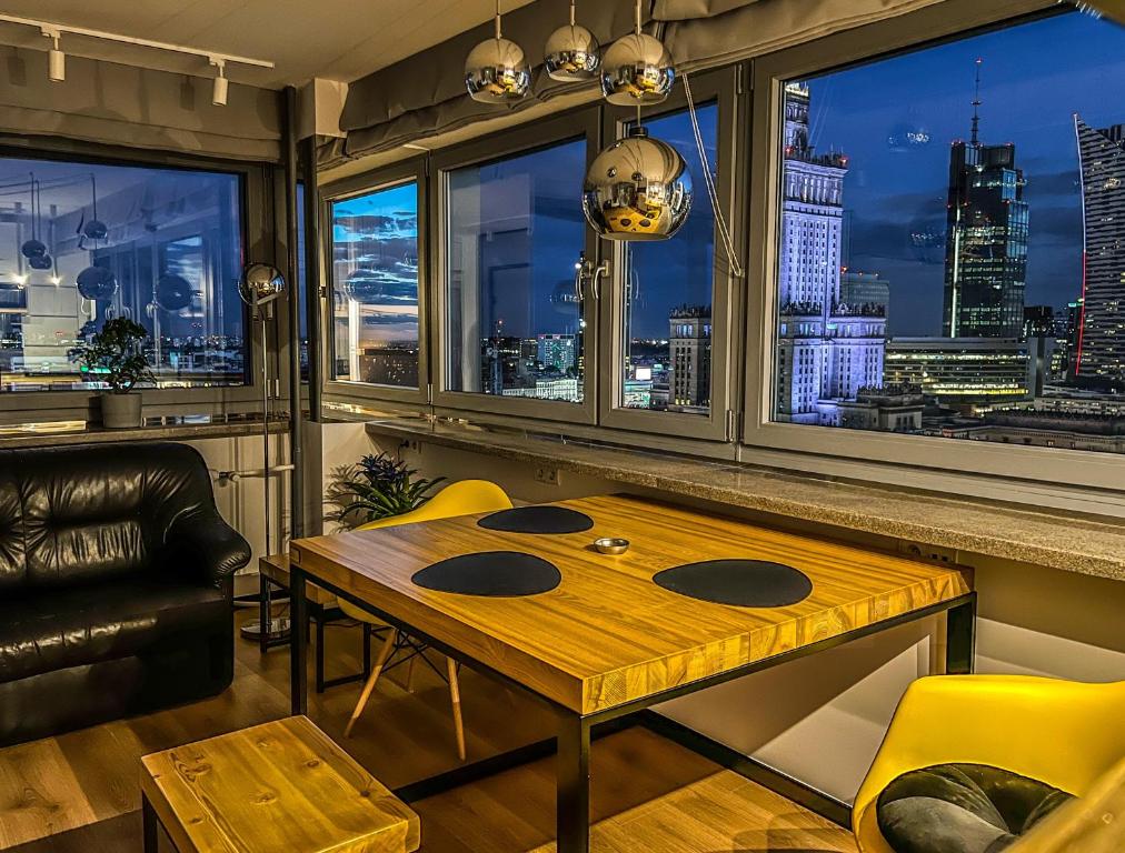 a room with a table and a view of a city at Sleep4you Apartamenty Centrum in Warsaw