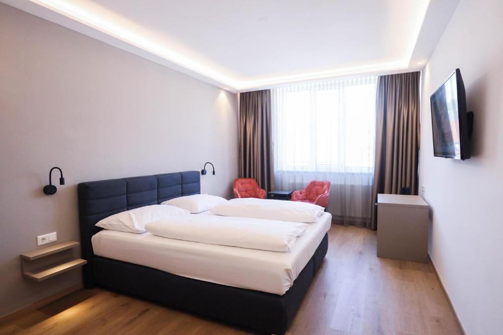 Ένα ή περισσότερα κρεβάτια σε δωμάτιο στο PARKHOTEL Krems
