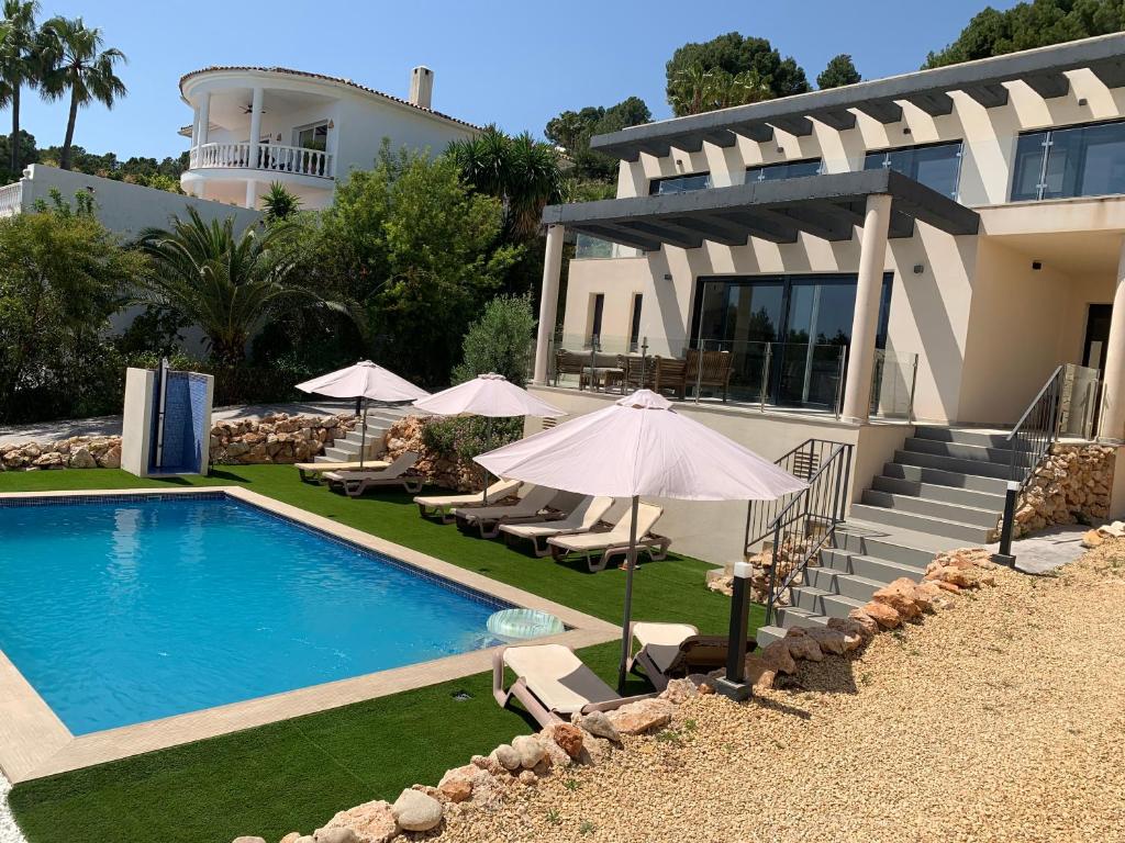 una casa con piscina frente a una casa en Villa Altea Lomalisa, en Altea