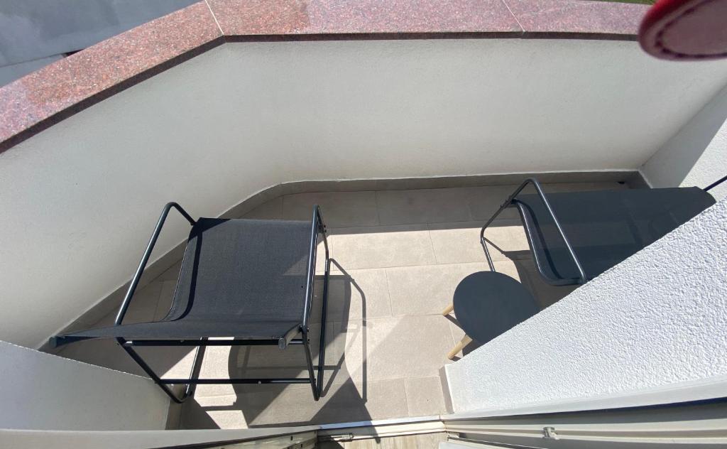 a balcony with two chairs on a building at Villa Mara in Pula