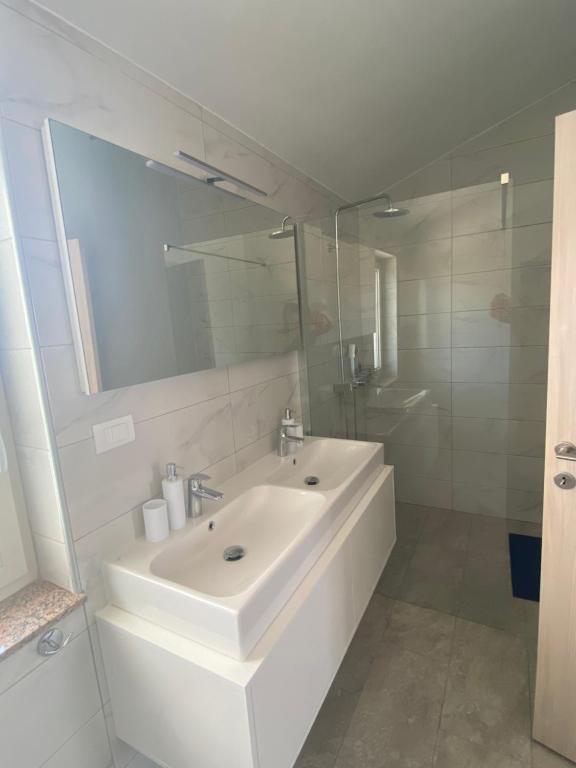 a white bathroom with a sink and a mirror at Villa Mara in Pula