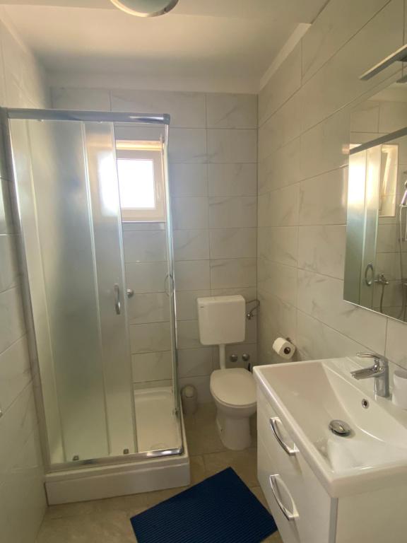 a bathroom with a shower and a toilet and a sink at Villa Mara in Pula