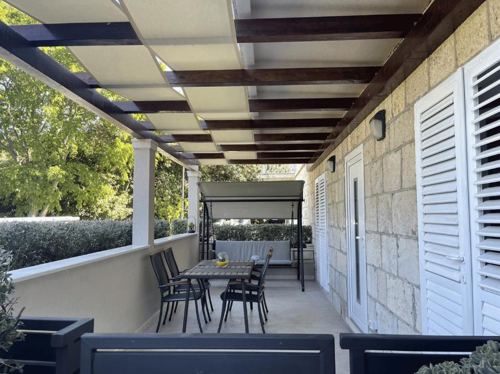 a patio with a table and chairs on it at Apartment Meri in Korčula