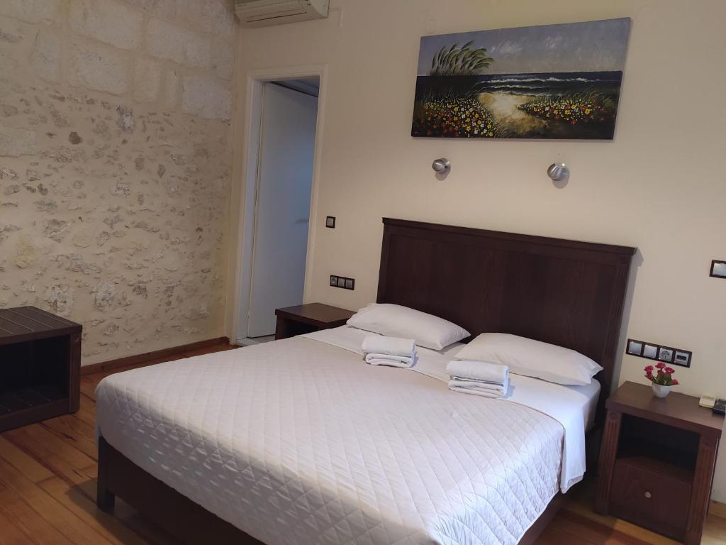 a bedroom with a bed with two towels on it at Sea Front Old Town in Rethymno Town