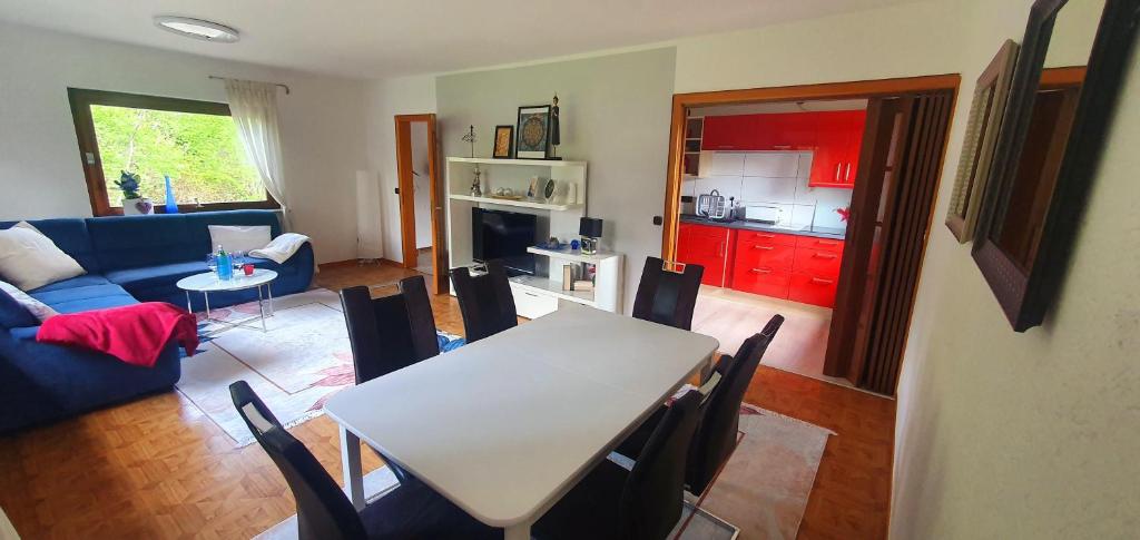 a living room with a table and a blue couch at Ferienwohnung-Haustaedter-Muehle in Lahnau