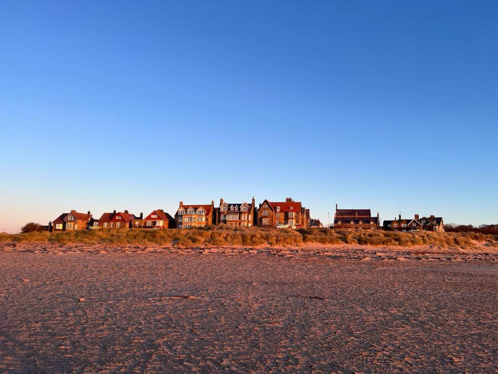 a row of houses on the shore of a beach at The Red Lion Inn Alnmouth in Alnmouth