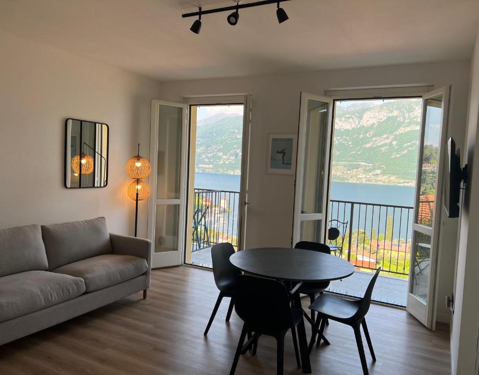 a living room with a couch and a table and chairs at OLIVE TREE LAKE VIEW APARTMENT in Bellagio