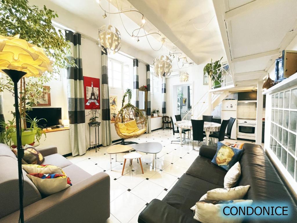 a living room with a couch and a table at CondoNice in Nice