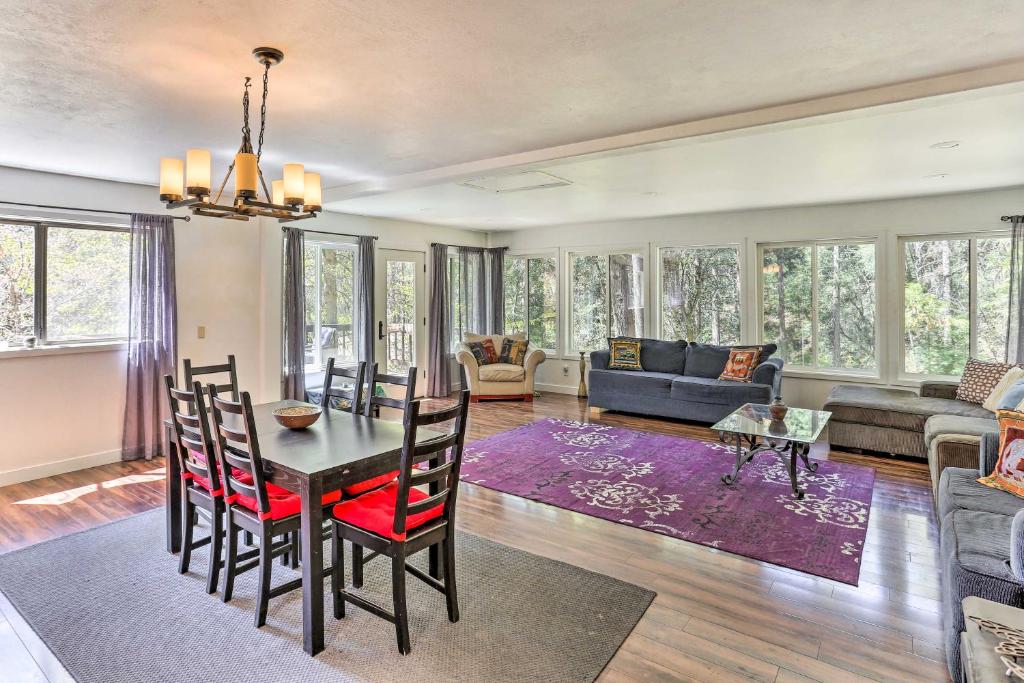 a dining room and living room with a table and chairs at Vibrant Weaverville Escape with Deck and Creek! in Weaverville