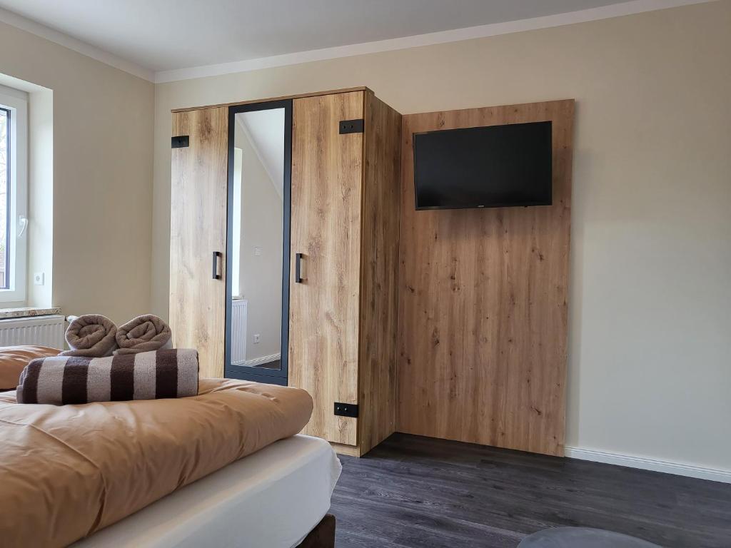 a living room with a couch and a flat screen tv at FeWo-Brak in Norden