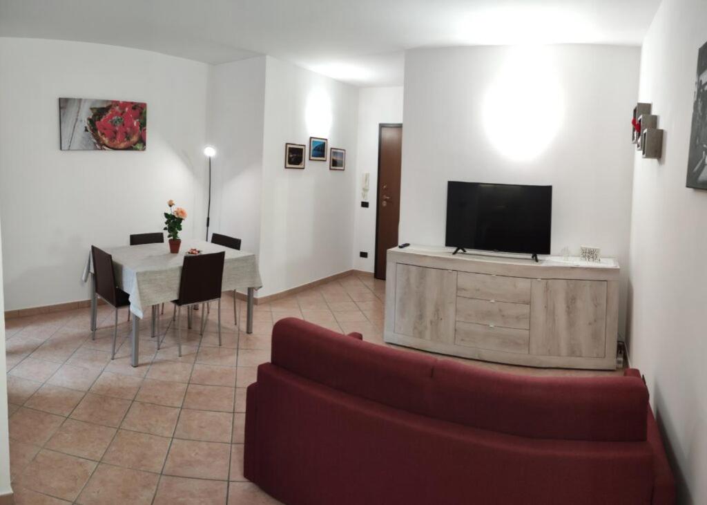 salon z kanapą, stołem i telewizorem w obiekcie Rosahouse w mieście Lecce