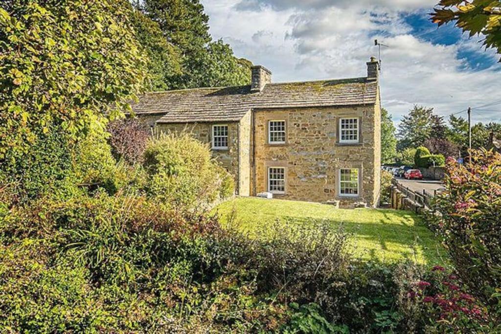 an old stone house in the middle of a yard at The Aubrey - a gorgeous converted 17th Century Grade II listed bolthole in Bakewell in Bakewell