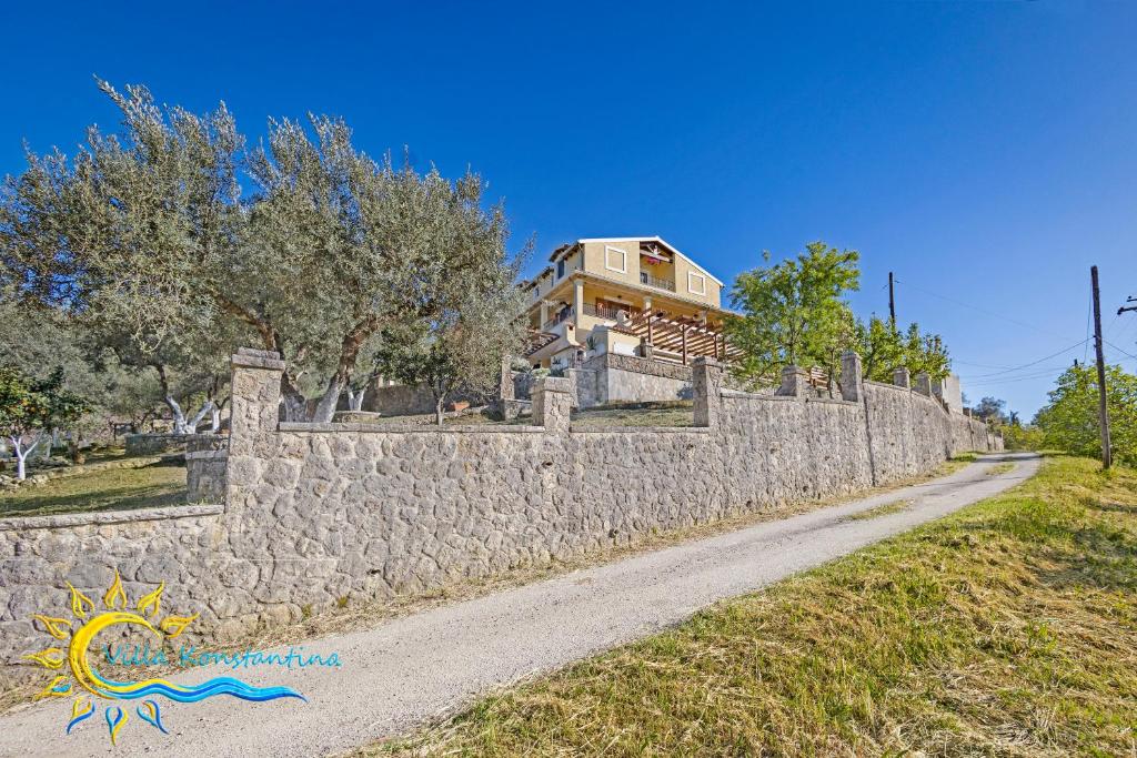 a stone wall in front of a house at VILLA KONSTANTINA Sidari in (( Sgoúrna ))