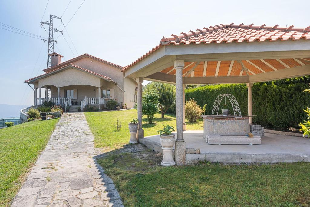 a gazebo in front of a house at GuestReady - Crestuma Bright in Crestuma