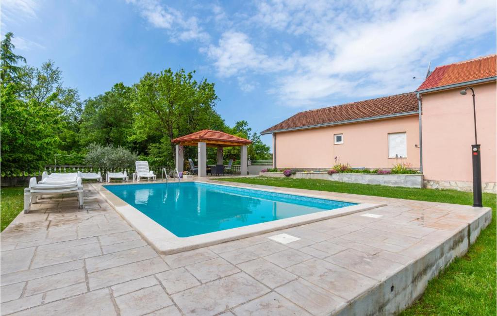 a swimming pool in the backyard of a house at Lovely Home In Neoric With Wifi in Neorić