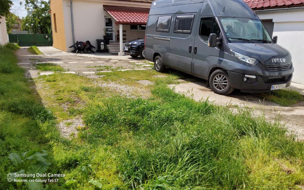 a van parked in the driveway of a house at A flat 3 in Bratislava