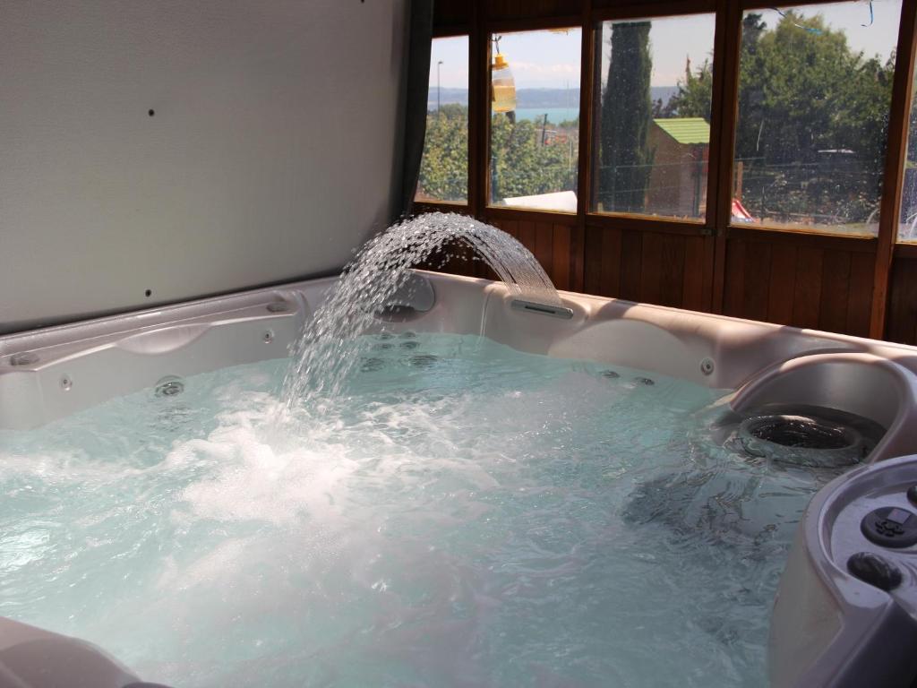 a bath tub with a water fountain in it at chez moumie jacuzzi privatif in Bevaix