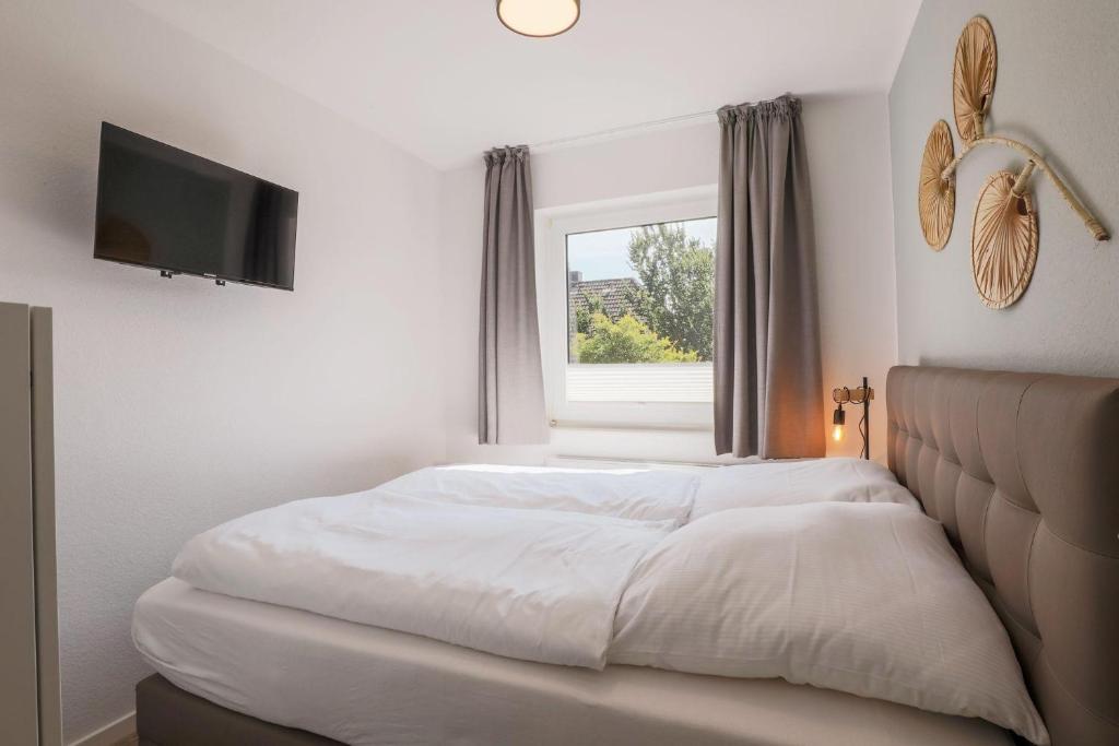 Postel nebo postele na pokoji v ubytování Haus Treibholz Apartment 7