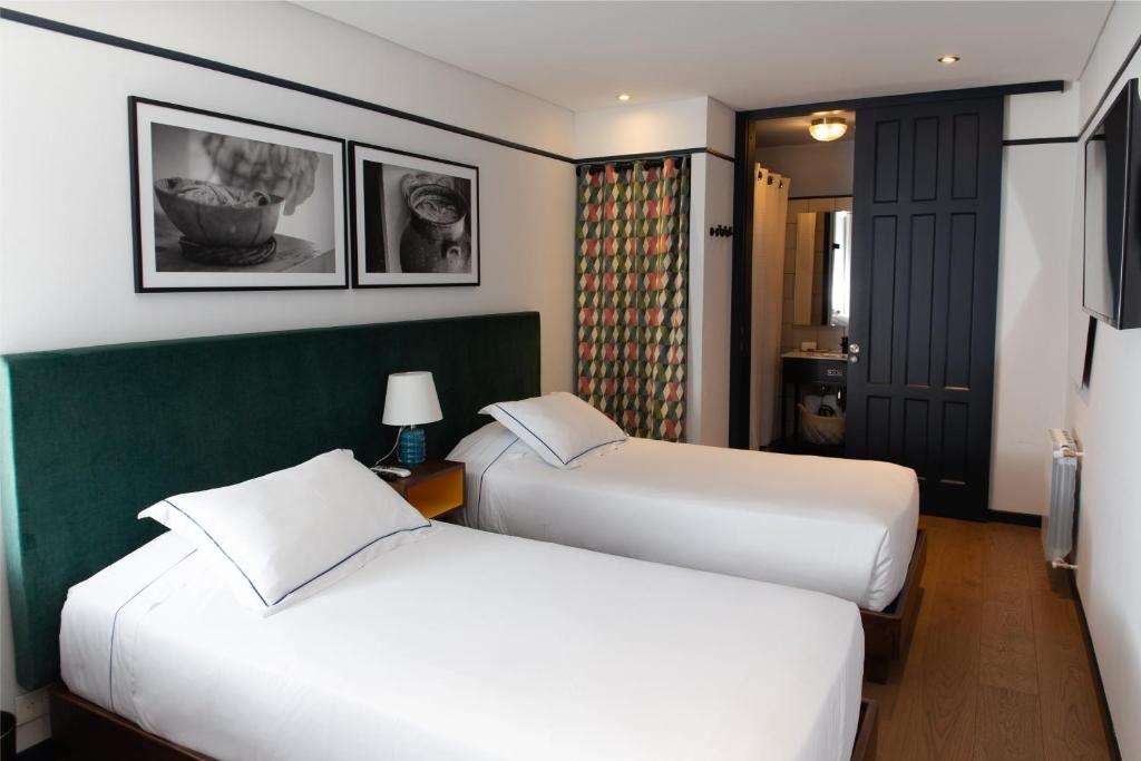 Postel nebo postele na pokoji v ubytování HAB Hotel Bogotá