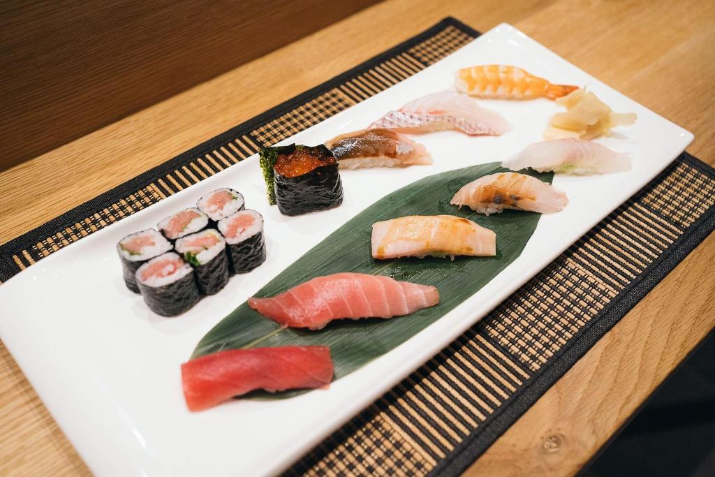 a white plate of sushi on a table at Henn na Hotel New York in New York