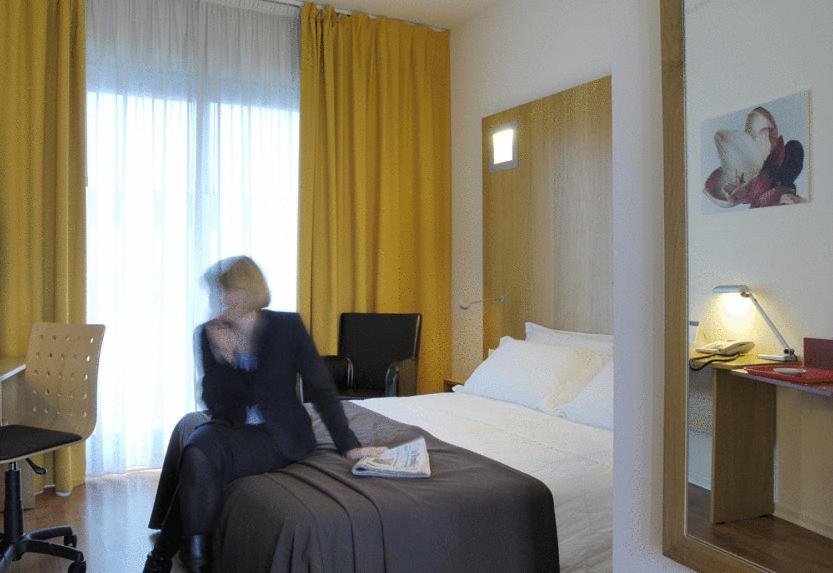 Postel nebo postele na pokoji v ubytování Executive Hotel