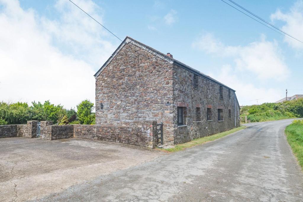 an old stone barn on a dirt road at Penbarden Barn in Bude