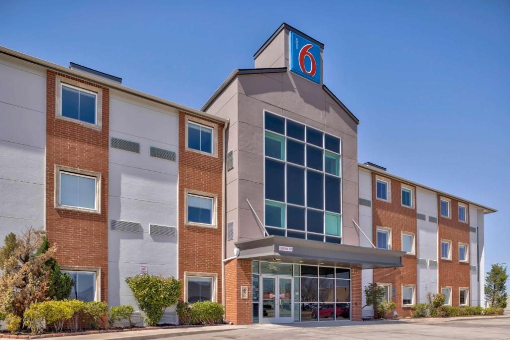 a building with a clock on the top of it at Motel 6-Norman, OK in Norman