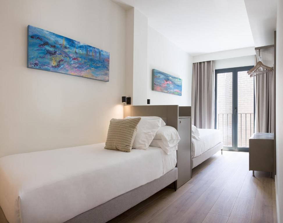 Posteľ alebo postele v izbe v ubytovaní Puerta Catedral Suites