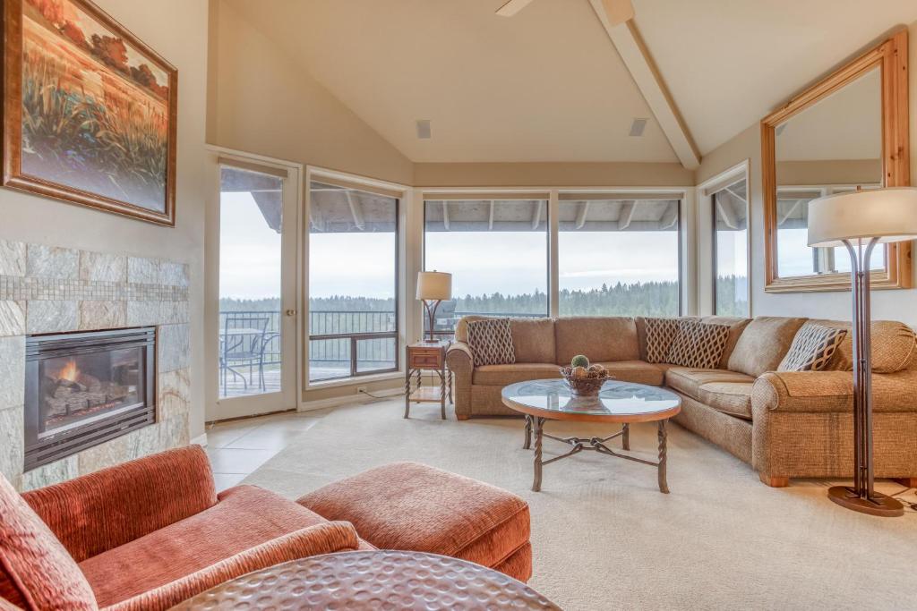 a living room with couches and a fireplace at River Ridge 421AB - Meredith Lodging in Bend
