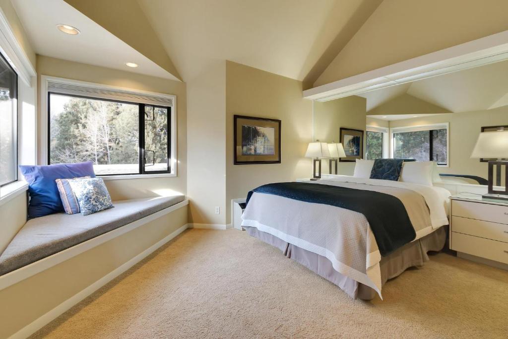 a bedroom with a large bed and two windows at River Ridge 423B in Bend