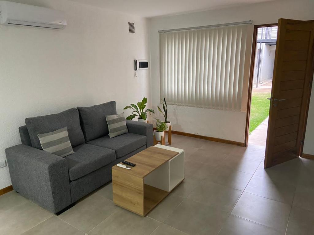 a living room with a couch and a coffee table at Departamento 2 habitaciones planta baja Hasta 4 huéspedes in Tunuyán