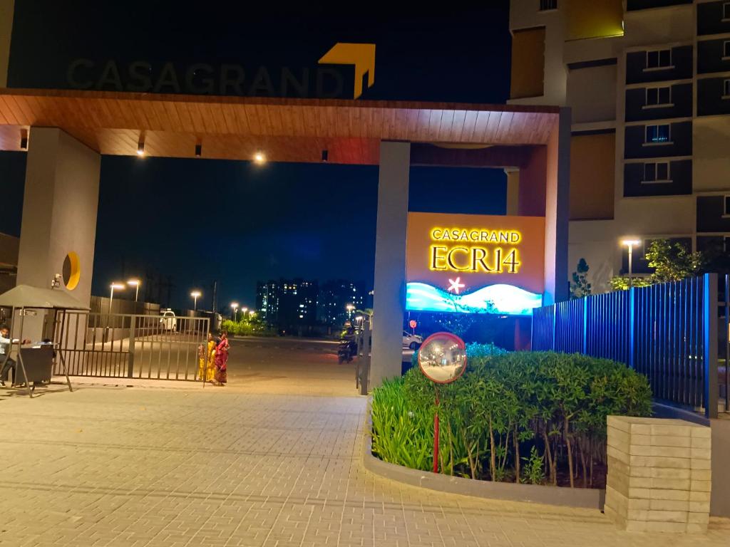 a sign in front of a building at night at Oviyam Sea view Apartment, feel like home in Chennai