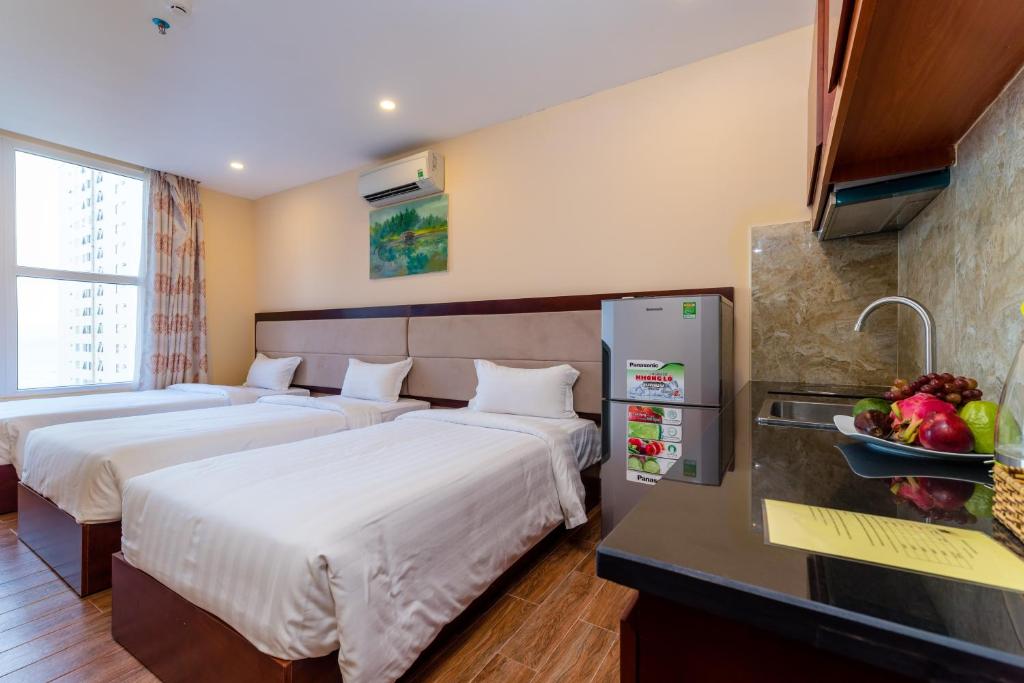 Postel nebo postele na pokoji v ubytování Nhat Minh Hotel and Apartment