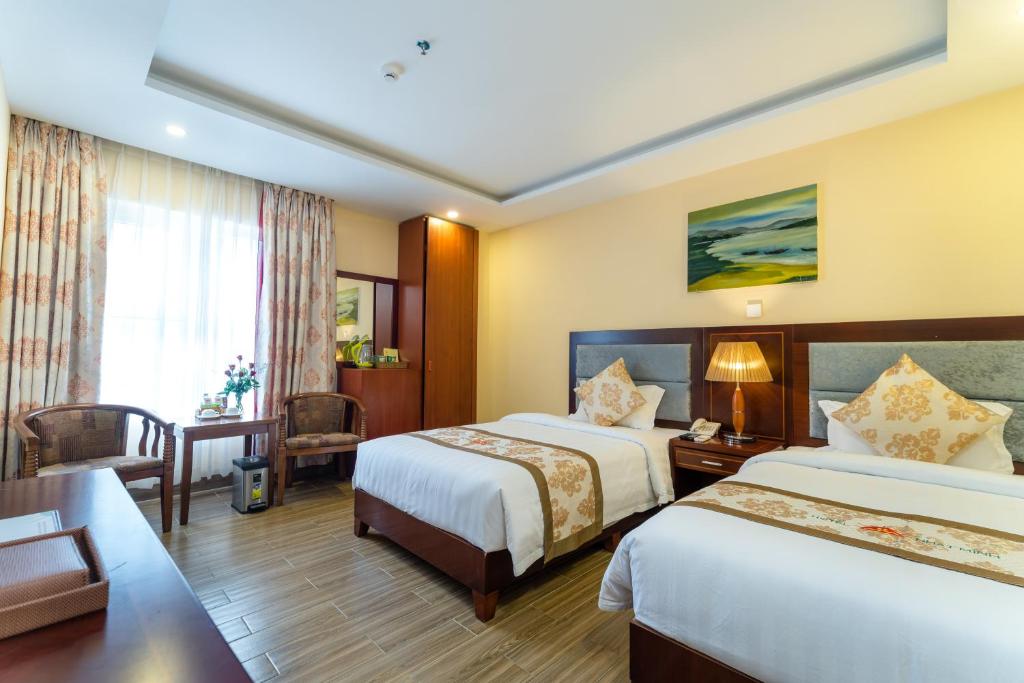 Postel nebo postele na pokoji v ubytování Nhat Minh Hotel and Apartment