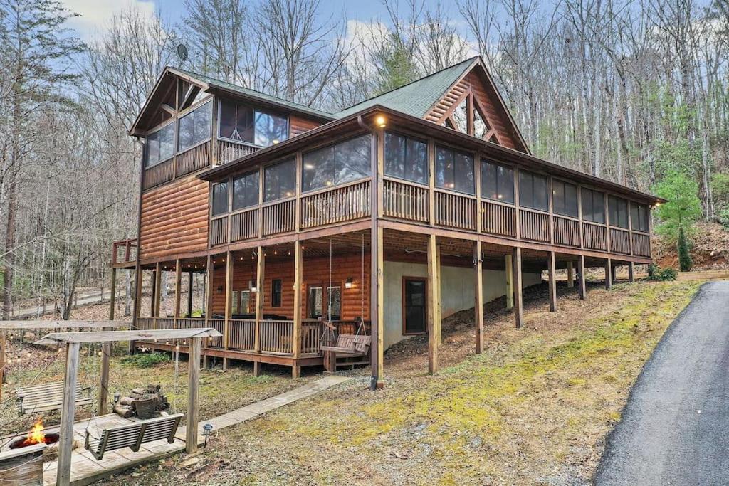 a large wooden house with a lot of windows at Relaxing Cabin near Bear Claw Vineyard, Hot Tub, Game Room, Pet Friendly, sleeps10 in Blue Ridge