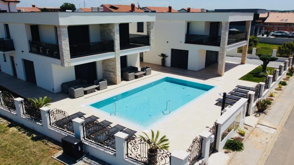an aerial view of a house with a swimming pool at Vila Softic Amra in Umag