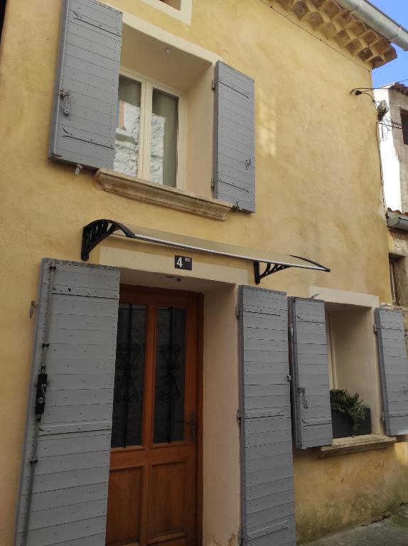 a house with shuttered windows and a wooden door at Navajos in Buis-les-Baronnies