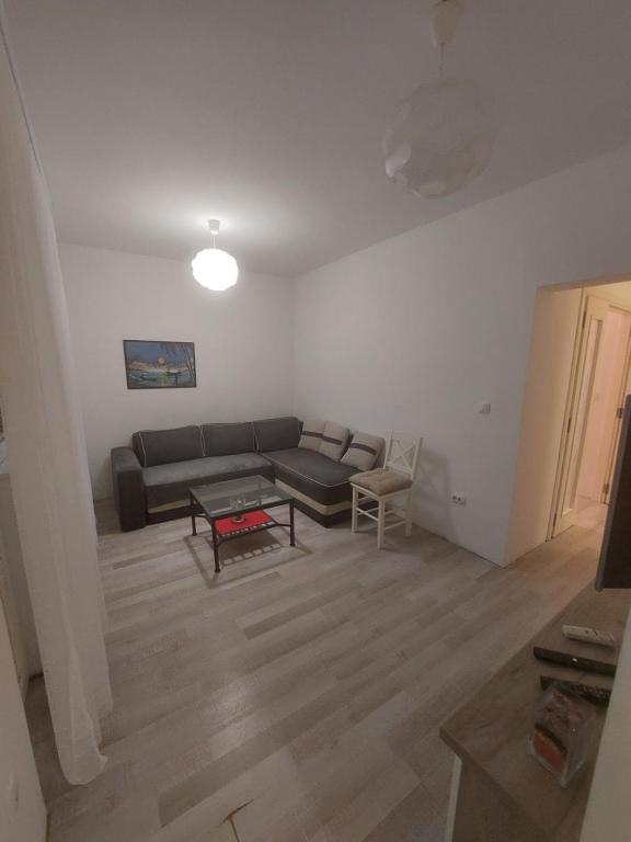- un salon avec un canapé et une table dans l'établissement APARTMAN ADA, à Čukarica