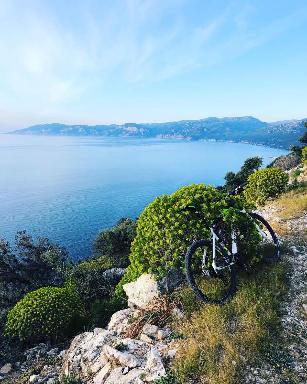a bike parked on a hill next to the water at Biriola EcoResort Cala Gonone in Cala Gonone