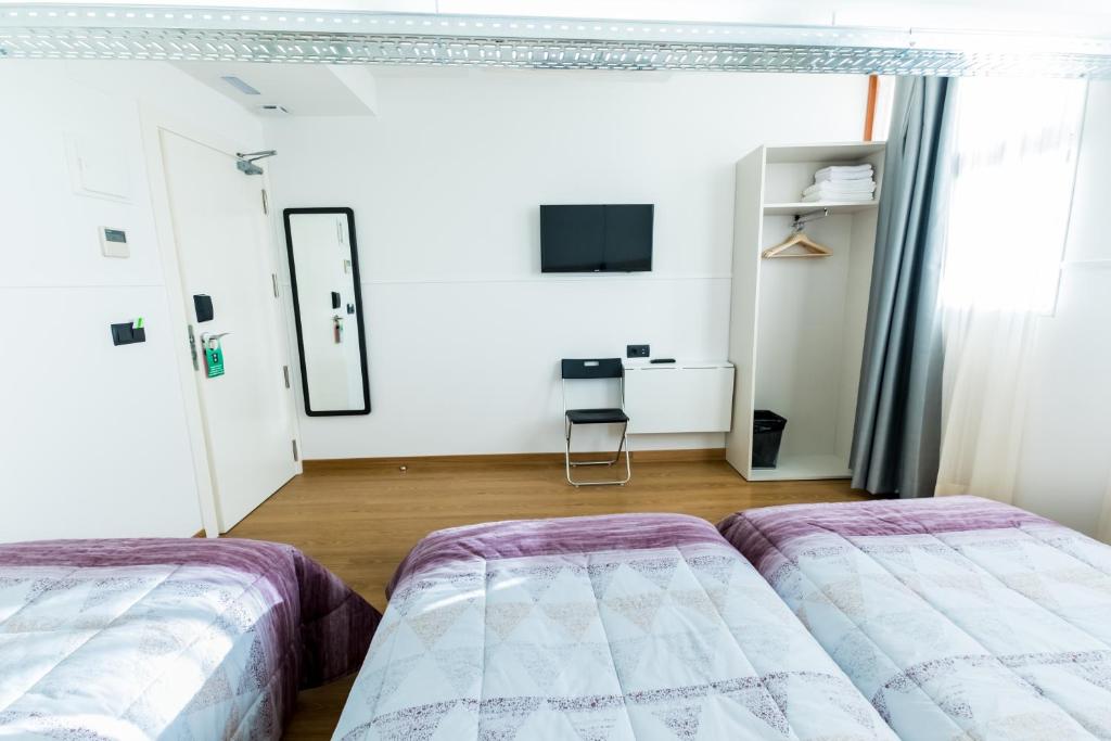 Cama o camas de una habitación en Far Home Bernabeu