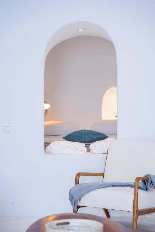 a row of beds in a room with a mirror at Aristos Life Luxury Cave Villas in Oia