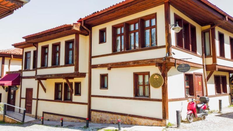 a building with a scooter parked in front of it at Arasta Konak Otel in Eskisehir