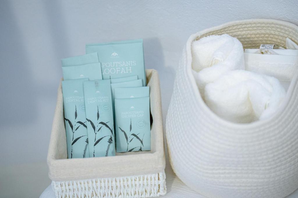a white basket with a bunch of products in it at Aristos Life Luxury Cave Villas in Oia