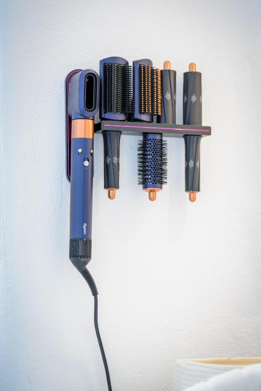 a wall mounted tool holder with a bunch of tools at Aristos Life Luxury Cave Villas in Oia