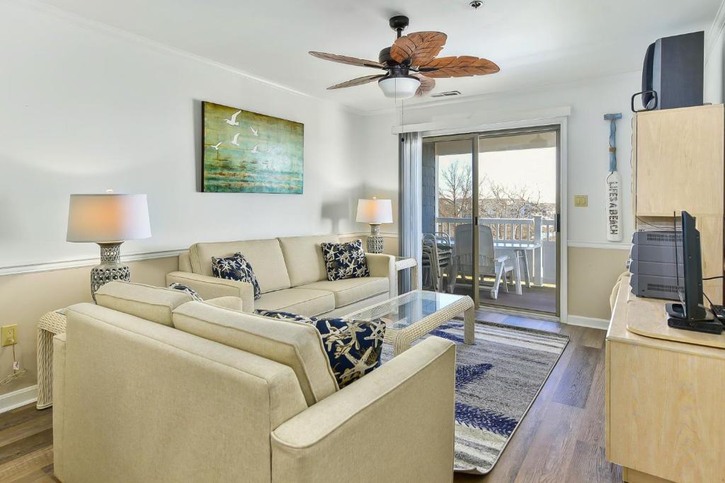 a living room with two couches and a ceiling fan at Harbour Club 12G in Ocean City